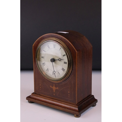 107 - An early 20th century mahogany dome topped mantle clock with string inlay decoration.