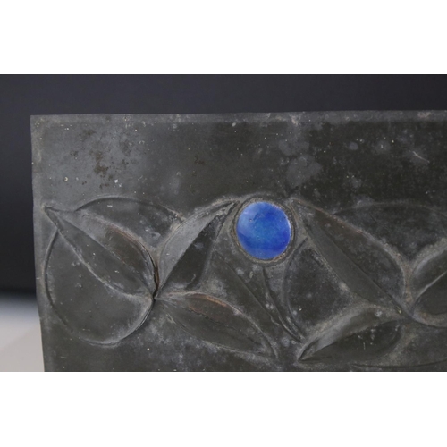 115 - Arts and Craft Pewter Panel with relief leaf decoration and two blue Ruskin style cabochons, 36cms x... 