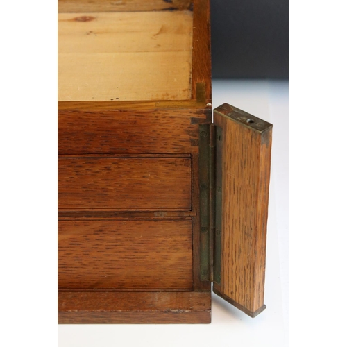 117 - An early 20th century oak two drawer canteen with brass handles.