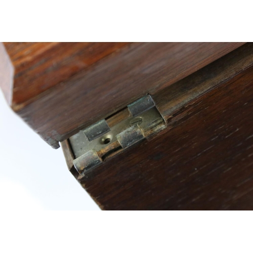 117 - An early 20th century oak two drawer canteen with brass handles.