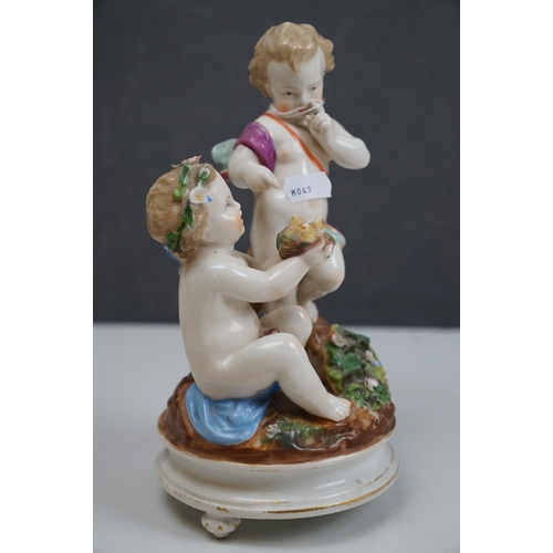 150 - A ceramic figurine of two cherubs with a birds nest, crossed swords mark to base.