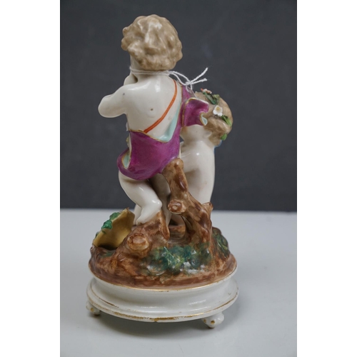 150 - A ceramic figurine of two cherubs with a birds nest, crossed swords mark to base.