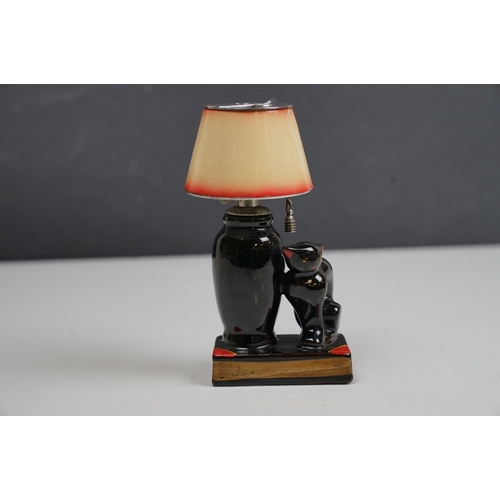 166 - A vintage ceramic table lighter in the form of a lamp with black cat.