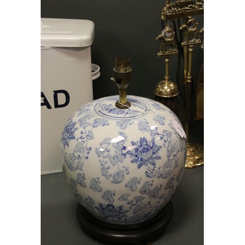 72 - A group of collectables to include a brass companion set, enamel bread bin and a blue & white lamp.