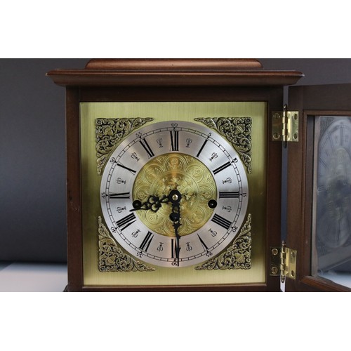 92 - A mahogany cased two train movement bracket clock with brass face and carrying handle.