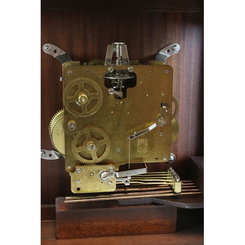 92 - A mahogany cased two train movement bracket clock with brass face and carrying handle.