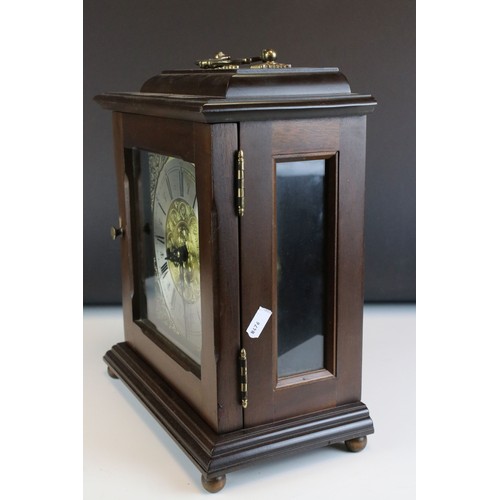 92 - A mahogany cased two train movement bracket clock with brass face and carrying handle.