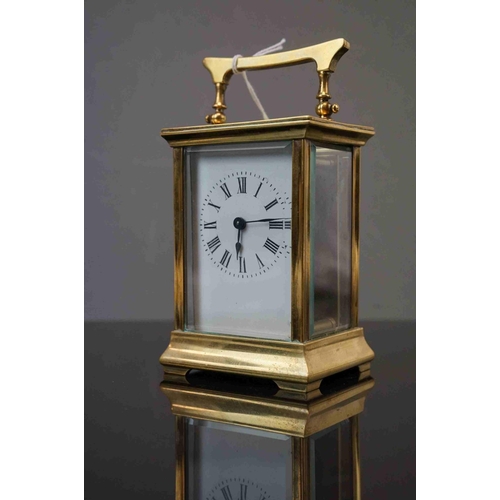 200 - A vintage brass cased carriage clock with white enamel dial, complete with key.