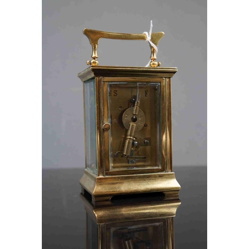 200 - A vintage brass cased carriage clock with white enamel dial, complete with key.