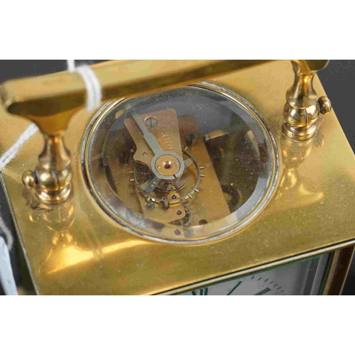 200 - A vintage brass cased carriage clock with white enamel dial, complete with key.