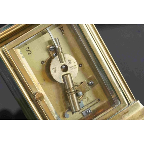 200 - A vintage brass cased carriage clock with white enamel dial, complete with key.