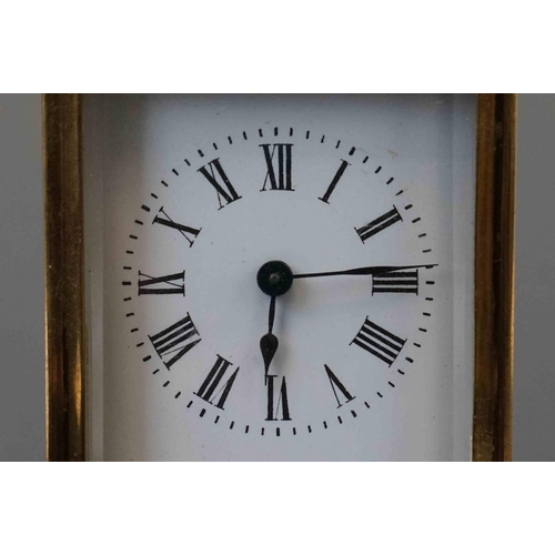 200 - A vintage brass cased carriage clock with white enamel dial, complete with key.