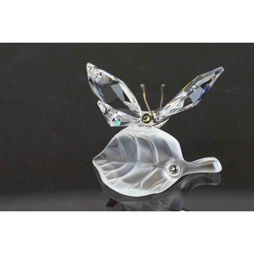 207 - Two boxed Swarovski ornaments to include a butterfly (A 7639) and a butterfly on a leaf (A 7615).