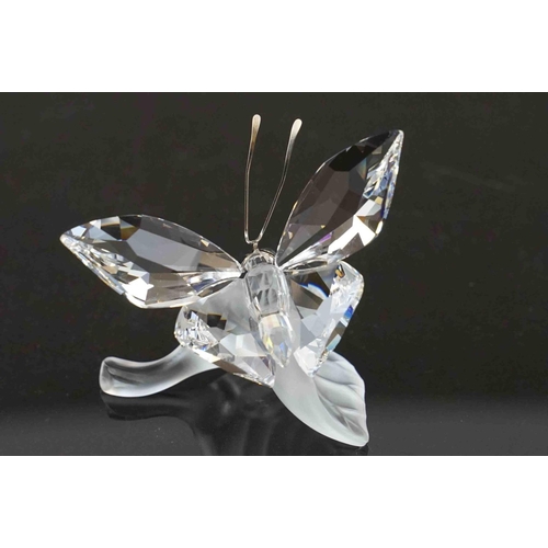 207 - Two boxed Swarovski ornaments to include a butterfly (A 7639) and a butterfly on a leaf (A 7615).