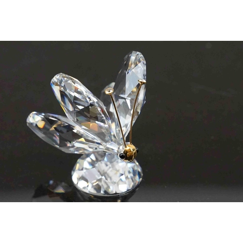 207 - Two boxed Swarovski ornaments to include a butterfly (A 7639) and a butterfly on a leaf (A 7615).