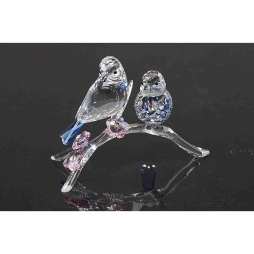 208 - A boxed Swarovski crystal ornament of birds on a branch.