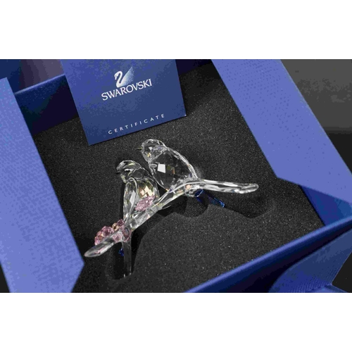 208 - A boxed Swarovski crystal ornament of birds on a branch.