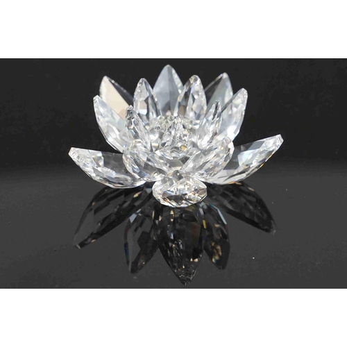 210 - A collection of six boxed Swarovski crystal ornaments to include a swan, a lotus flower and other wi... 