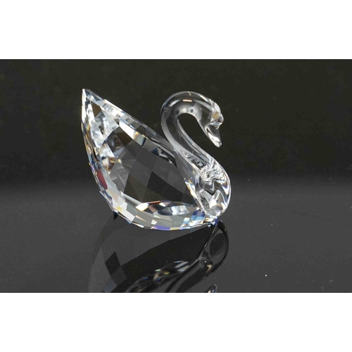 210 - A collection of six boxed Swarovski crystal ornaments to include a swan, a lotus flower and other wi... 