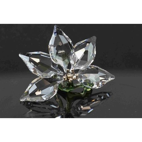 210 - A collection of six boxed Swarovski crystal ornaments to include a swan, a lotus flower and other wi... 