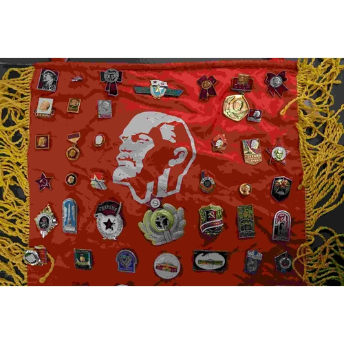 218 - A collection of USSR / CCCP Russian propaganda badges attached to a similar flag.