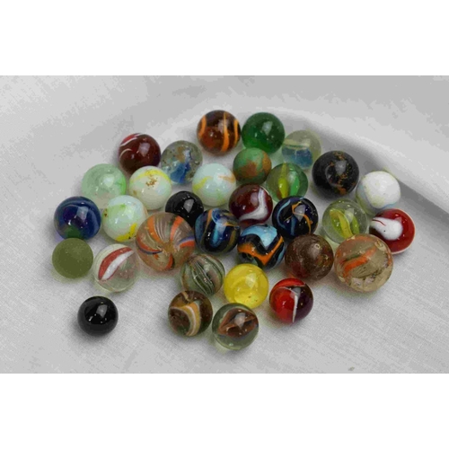 242 - A small collection of vintage glass marbles.