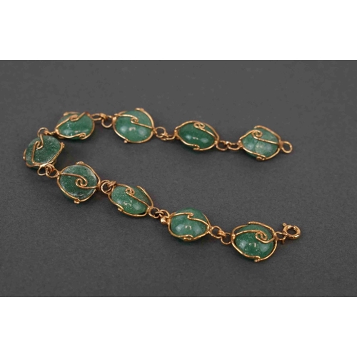 270 - A set of jade and yellow metal jewellery to include necklace, bracelet and earrings.