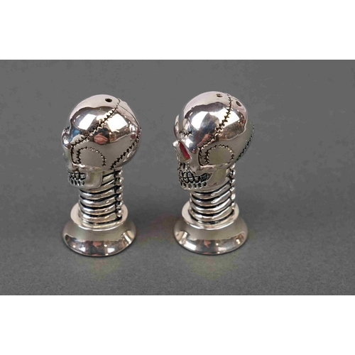 291 - Pair of silver plated condiments in the form of skulls with ruby eyes