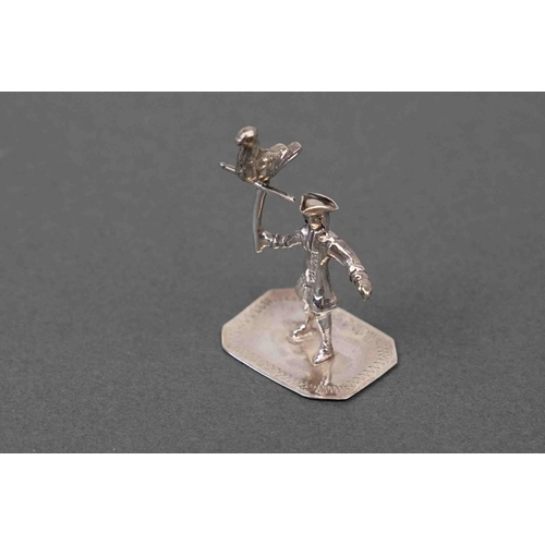 293 - Silver figure of a pirate holding a bird