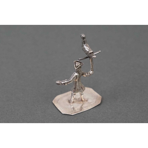 293 - Silver figure of a pirate holding a bird