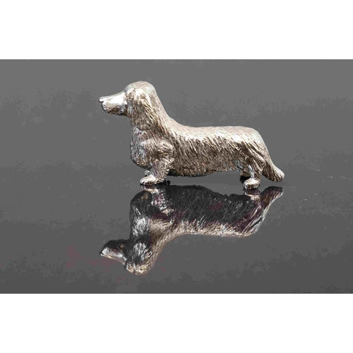 312 - A small group of three cast metal dog figures to include a dachshund.