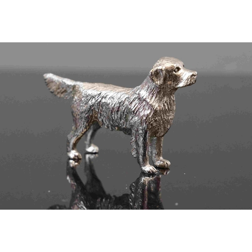 312 - A small group of three cast metal dog figures to include a dachshund.