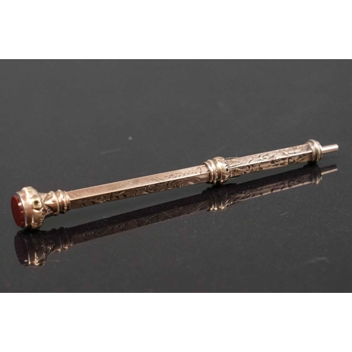 318 - An antique 9ct gold propelling pencil with carnelian finial.