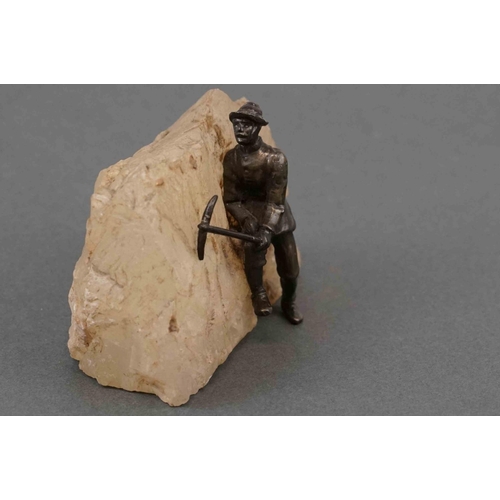 326 - A vintage bronzed figure of a mountain climber mounted to quartz.