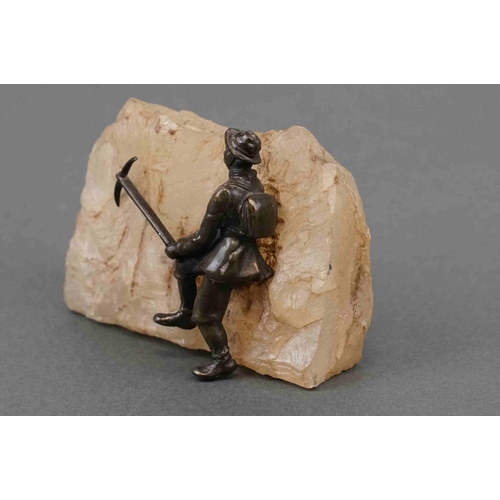 326 - A vintage bronzed figure of a mountain climber mounted to quartz.