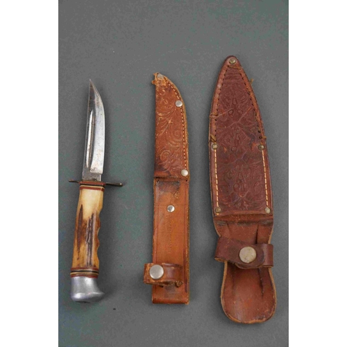 340 - Two American pen knives together with a German sheath knife and another similar example.