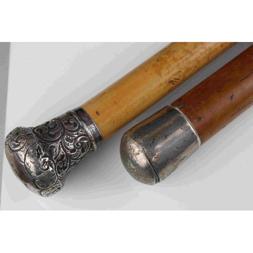 108 - An antique silver topped walking cane and one other similar with white metal handle.