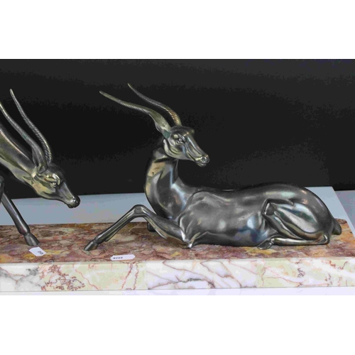 112 - Art Deco pair of spelter Antelope mounted on a marble plinth, 55cms long