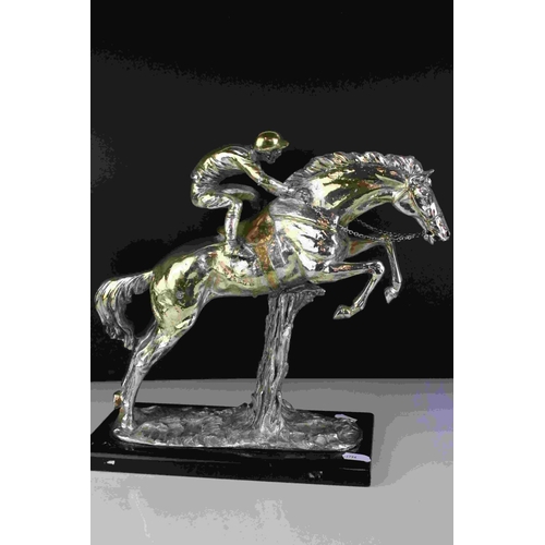 42 - Silver plated and gilt sculpture of a jockey and horse jumping hurdles signed Santini, 33cms high