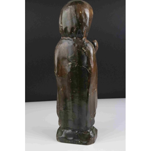 48 - A carved wooden figure of a religious figure.