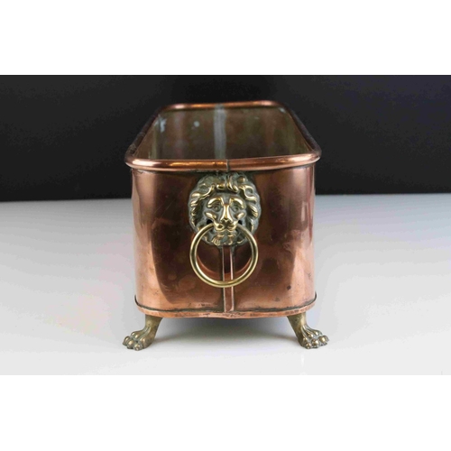 58 - Copper Rectangular Planter with brass lion mask handles and paw feet, impressed indistinct maker to ... 