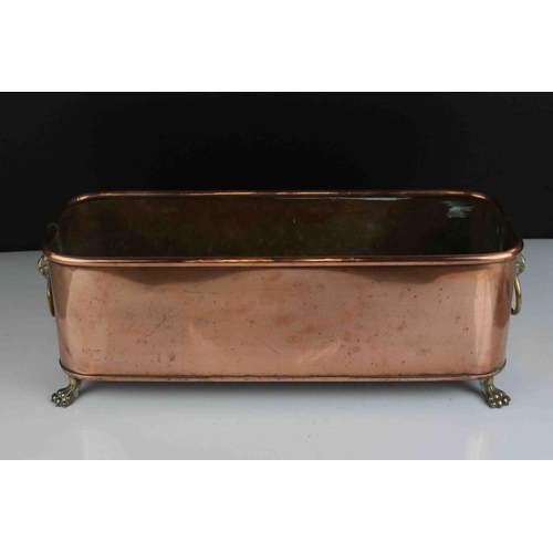 58 - Copper Rectangular Planter with brass lion mask handles and paw feet, impressed indistinct maker to ... 