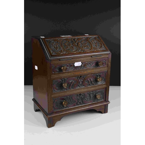 61 - Mahogany Apprentice Piece Bureau with carved decoration to door fronts raised on bracket feet, 28cms... 