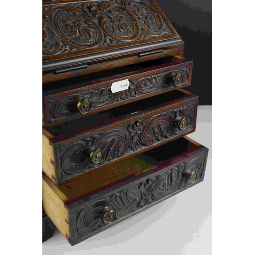 61 - Mahogany Apprentice Piece Bureau with carved decoration to door fronts raised on bracket feet, 28cms... 