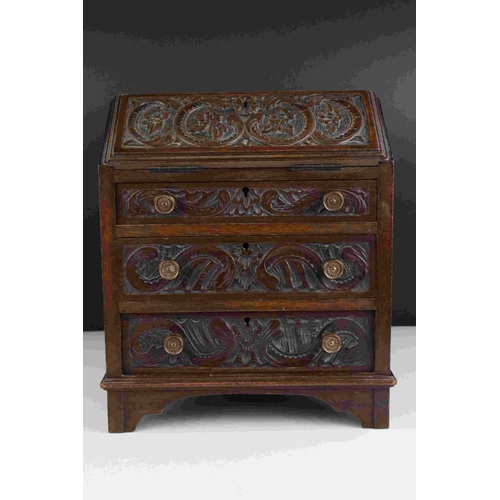 61 - Mahogany Apprentice Piece Bureau with carved decoration to door fronts raised on bracket feet, 28cms... 