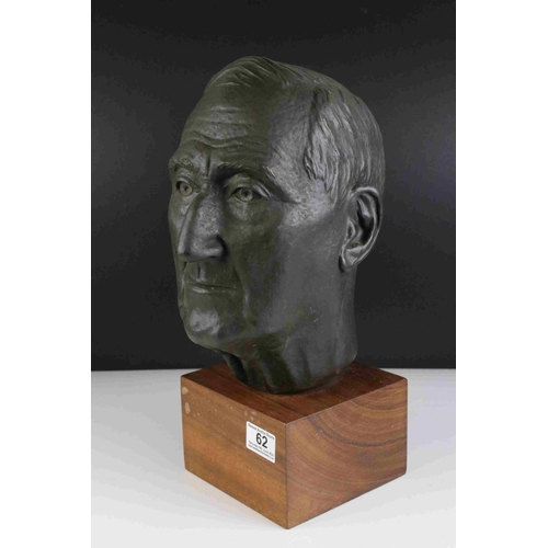 62 - A 20th century hollow bronzed bust of a man mounted on a wooden plinth unsigned.