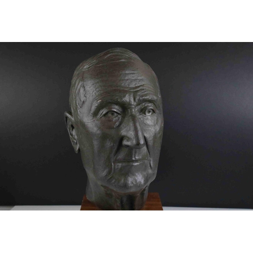 62 - A 20th century hollow bronzed bust of a man mounted on a wooden plinth unsigned.