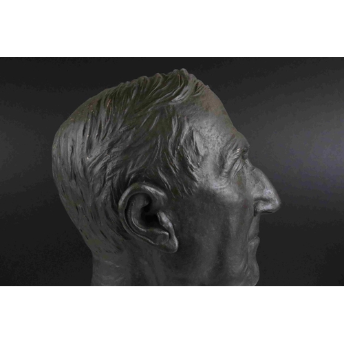 62 - A 20th century hollow bronzed bust of a man mounted on a wooden plinth unsigned.