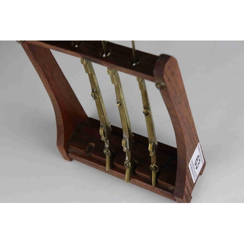 63 - Four Trench Art Brass Desk Paperknives in the form of  Rifles contained within a wooden gun rack, 20... 