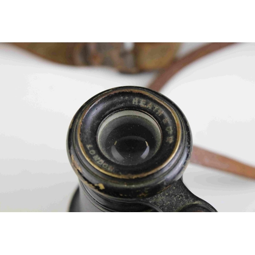 83 - A pair of world war one era British military issued field binoculars, marked with the broad arrow an... 